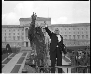 Rev. Ian Paisley leader of the DUP, MLA and MEP posing beside the statue of Sir Edward Carson in front of the Stormont building, and shot of statue alone