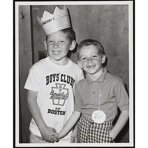 Freckle King Danny Hayes and an unidentified boy shake hands at the Boys' Club Freckle King Contest