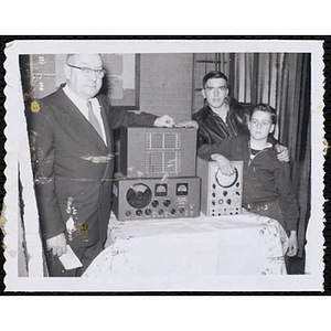 A Boys' Club staffer and two Club members stand with shortwave radios at the Awards Night Exhibit