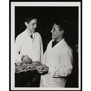 Two members of the Tom Pappas Chefs' Club pose with a muffin tray of popovers