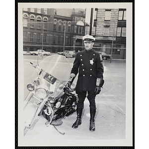 A Boston Police officer poses next to his motorcycle