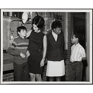 Mrs. Terri Buoniconti, at center left, and Mrs. Rosa Hunt, talking to two Boys' Club members