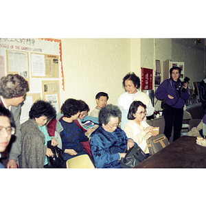 Audience donating money at a meeting between Mexican workers and the Chinese Progressive Association