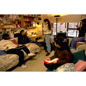 Students doing homework and socializing in a dorm room