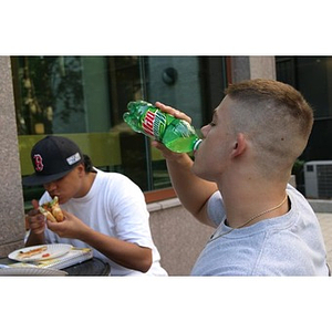 Joseph Bordieri drinks Mountain Dew at the Torch Scholars Question and Answer Pizza Party