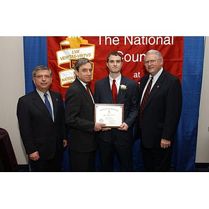 Inductee Joshua Seadia poses with his certificate and three others at the National Council Dinner