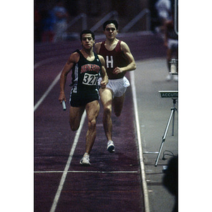 A Northeastern student, number 327, from the men's indoor track and field team competing in the Greater Boston Championships at Harvard