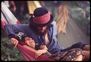 Couple snuggling in a hammock at the Woodstock Festival