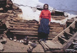 Woman and chicks outside Volce outbuilding