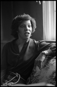 Portrait of singer Martha Reeves, seated on a sofa