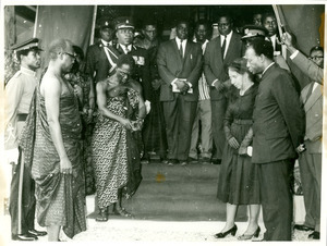 Nana Nketsi pouring libations to the gods of Africa, Kwame Nkrumah, Shirley Graham Du Bois, and others with heads bowed