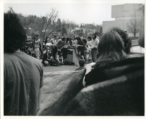 Board of Trustees fee increase demonstration: protestors holding banner and listening to a speaker in front of the Whitmore Administration Building