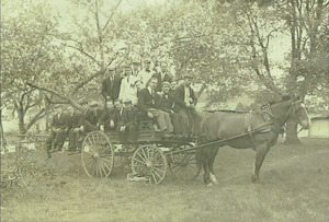 Class of 1910 students with a horse-drawn carriage