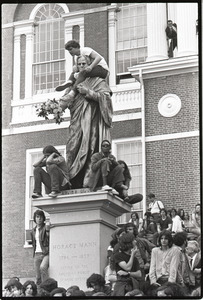 Demonstration at State House against the killings at Kent State: protesters on statue of Horace Mann