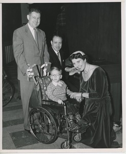 Willis C. Gorthy and Rose Bampton with young boy in wheelchair at Christmas party