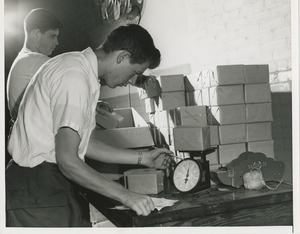 Young man with cerebral palsy performing packaging job for work evaluation