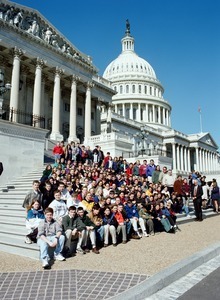 Congressman John W. Olver and large group of visitors, posed on the steps of the United States Capitol building