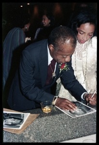 James Baldwin autographing a photo for Onita Estes-Hicks at his 60th birthday celebration, UMass Campus Center