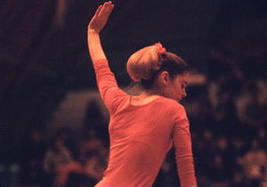Lucy Miller with her hand raised in the air