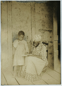 Black woman and child read together in Louisiana