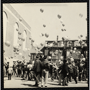 Boys' Club members releasing the balloons with messages attached. A caption on the back of the photograph states "Go!"