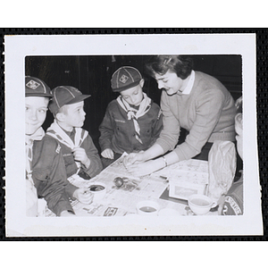 An art instructor teaching several boys in Boy Scouts uniform at the Charlestown Boys' Club