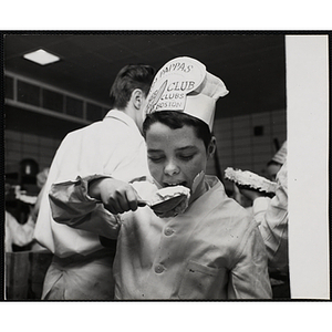 A member of the Tom Pappas Chefs' Club samples frosting in a Howard Johnson's kitchen