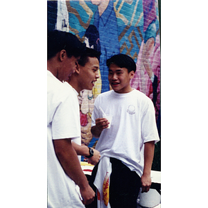 Boys talking in front of Unity / Community mural