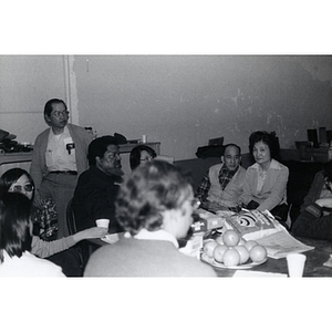 Chinese Progressive Association members around a table at a meeting