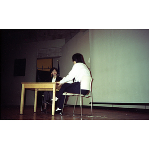 Two women talk at a voter registration event