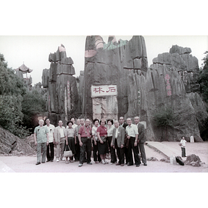 Association members pose in front of rock structures in an outdoor park