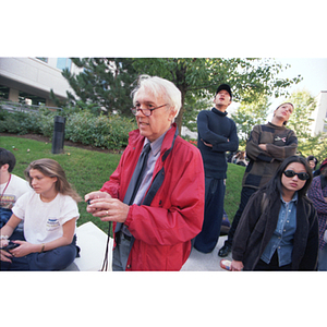 Professor Case and his students watch a pendulum swing from the Curry Student Center