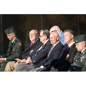 Several men in the audience at the Veterans Memorial dedication