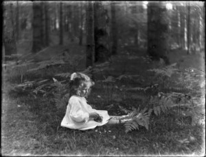 Young girl sitting in woods