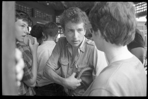 Bob Dylan, with bullwhip, surrounded by the crowd, Newport Folk Festival
