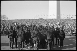 Performers from Bread and Puppet Theater wearing death's masks, facing the crowd near the Washington Monument: Washington Vietnam March for Peace