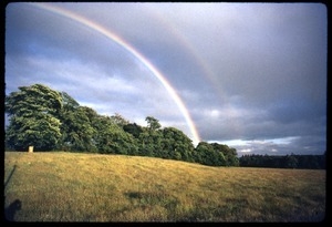 Double rainbow rising over a field during the Woodstock Festival