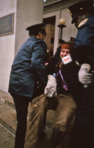 Police dragging a smiling woman