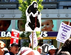 Protesters marching past the Babies R Us store with signs opposing the war in Iraq