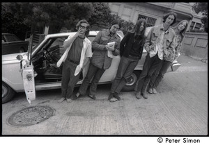 Five friends standing next to a parked car on a hilly street: Verandah Porche (second from left)