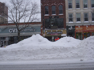 Plowed snow piled high in the middle of Main Street, Northampton, Mass., near intersection with Gothic St.