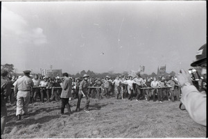 Antiwar demonstration at Fort Dix, N.J.: line of protesters holding pipe, advancing
