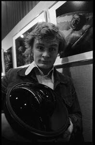 Jeff Albertson, holding a fish-eye lens at a photographic exhibition (possibly of work by David Doubilet)