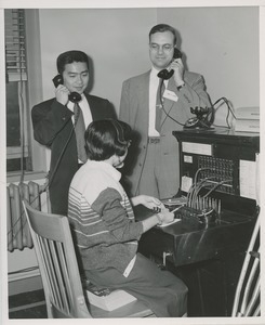 Barbara Sasso demonstrating her proficiency at switchboard operation for two onlookers