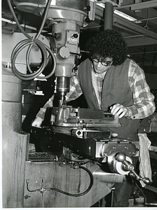 Unidentified man operating drill press