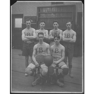 Group portrait of boys' basketball team in gym