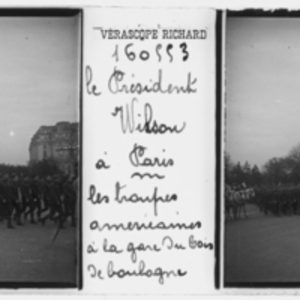 Troops walk in a parade in Paris for President Wilson
