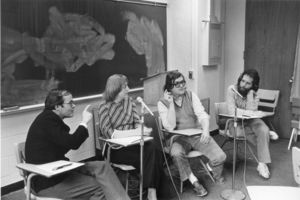 Suffolk University faculty meet in a classroom