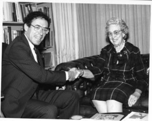 Suffolk University President Daniel H. Perlman (1980-1989) shaking hands with Mrs. Robert Munce