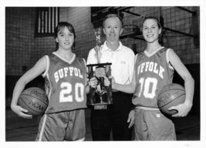 Suffolk University women's basketball player Kate Norton (left), Coach Ed Leyden (center) and player Amanda Markowski (right), posing with the 1996 Classic champions trophy, circa 1996